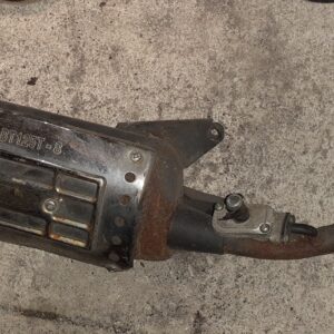 Tubo de escape original de segunda mano para Yuki Dak 125cc sobre suelo de cemento, detalle del silencioso cromado con código de homologación e4-BT125T-8 grabado.