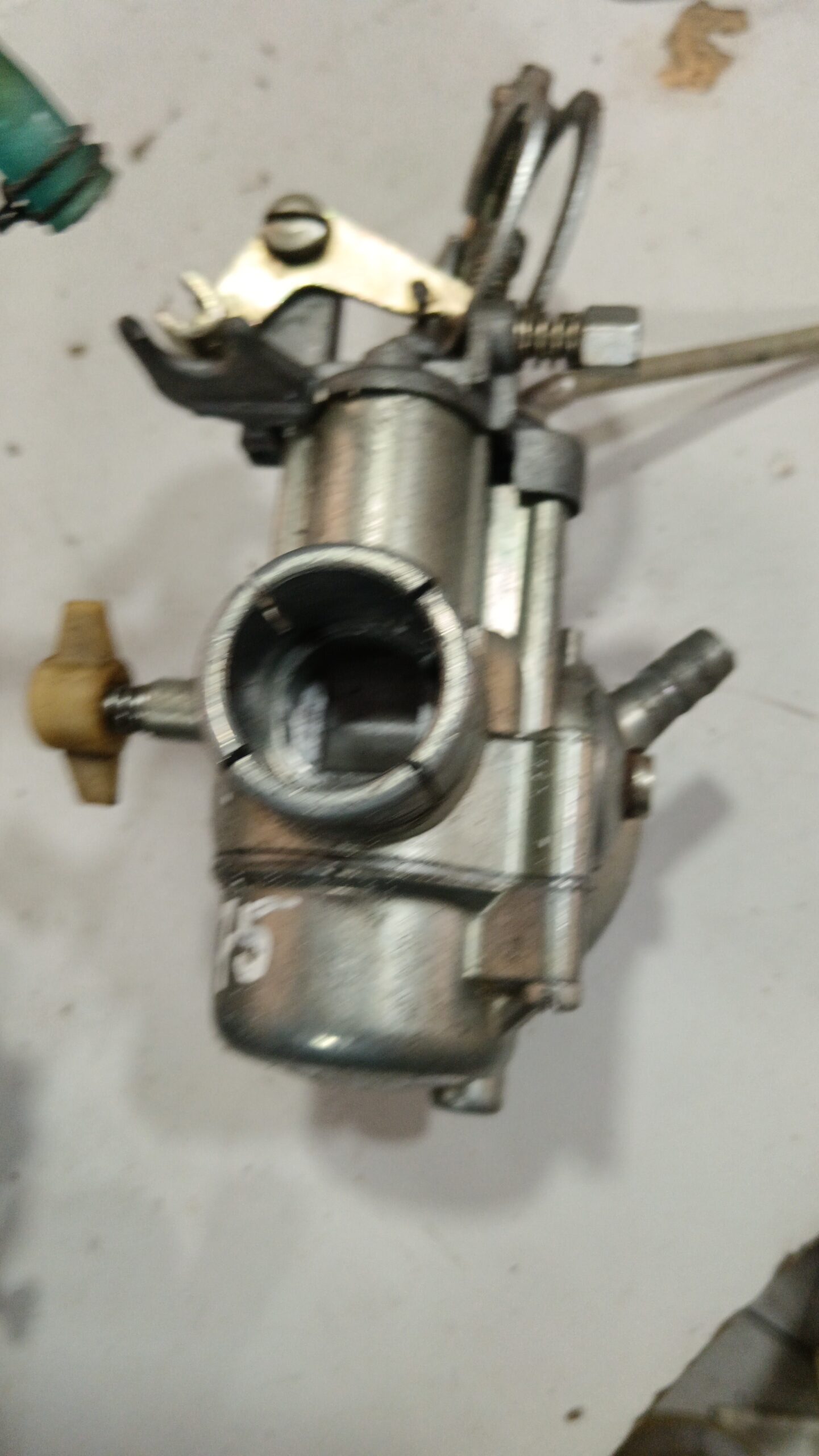 Toma de admisión trasera y cuba de carburador SHBC 19-19 para Vespa PK 75. Muestra la abrazadera de conexión al motor.