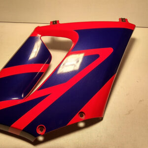 Carenado lateral derecho original azul y rojo con soportes superiores metálicos sanos para motocicleta Honda CBR 125 R.