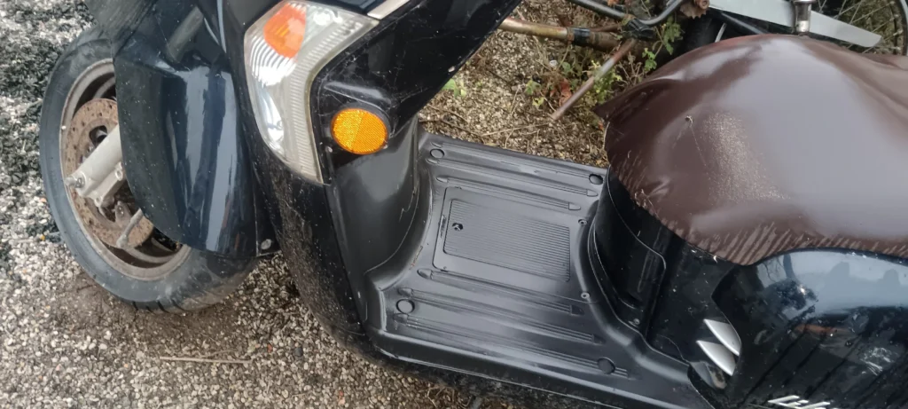 Plataforma reposapiés para scooter Kymco Like 50. Suelo de plástico original en color negro, recambio de desguace verificado.