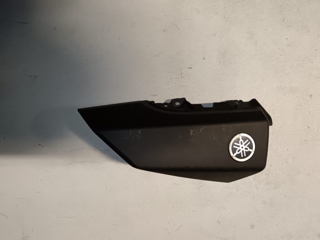 Tapa embellecedora frontal superior derecha original para Yamaha NMAX, color negro mate con logotipo oficial incluido.