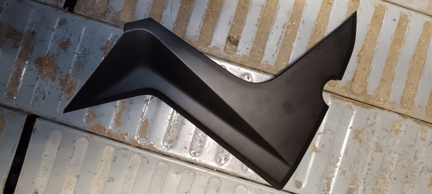 Tapa lateral tipo bumerán izquierda para Yamaha X-MAX 125 (2010-2013). Embellecedor de túnel central en plástico negro mate.