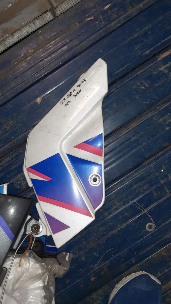 Tapa lateral izquierda de chasis para Suzuki GSXR 750 (1992-1993). Protector original en color blanco con gráficos azules.